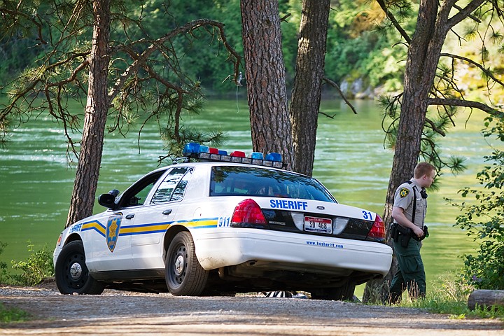 &lt;p&gt;Kootenai County Sheriff's Deputy A.C. Cady surveys the scene after the body of drowning victim Michael W. Blankartz, 28, of Spirit Lake, was returned to the shore where he and another man tipped their canoe early Thursday morning near Corbin Park in Post Falls.&lt;/p&gt;