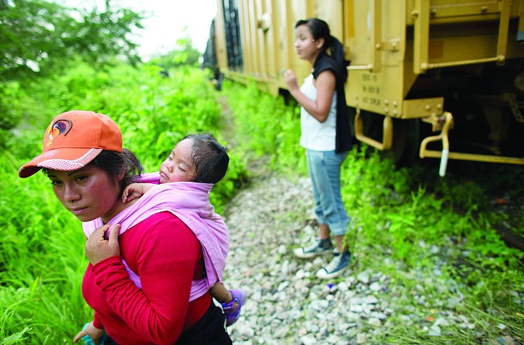 &lt;p&gt;&lt;span&gt;&lt;strong&gt;Guatemalan migrant&lt;/strong&gt; Gladys Chinoy, 14, right, waits June 20 with more than 500 other migrants, many traveling with small children, beside the stuck freight train outside Reforma de Pineda, Chiapas state, Mexico. Gladys said she was more excited about seeing her mother in the U.S. than she was scared about the trip. Reached by phone in New York City, her mother said she was aware of the dangers but had finally decided they were worth it after five years apart. The mother said, &#147;If she gets across, she can stay here, that&#146;s what you hear.&#148; (AP Photo)&lt;/span&gt;&lt;/p&gt;&lt;div&gt;&lt;span&gt;&#160;&lt;/span&gt;&lt;/div&gt;