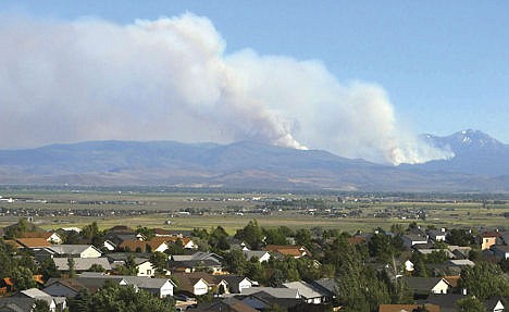 &lt;p&gt;Smoke from the Washington Fire rises over the mountains in Markleeville, Calif. The wildfire has grown to over 20 square miles in hazardous and inaccessible terrain south of Lake Tahoe and is moving closer to structures, officials said.&lt;/p&gt;