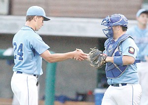 <p>Pitcher Jared Winslow shakes hands with catcher Micah Germany after defeating the Lewiston Cubs 2-0 in seven innings.</p>