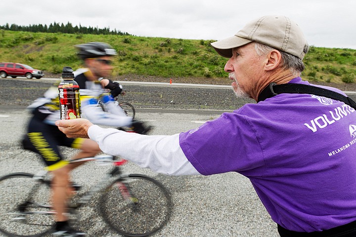 &lt;p&gt;SHAWN GUST/Press Don Carey, of Hayden Lake, volunteers in his third year, handing out energy drinks to cyclists during the Ironman triathlon.&lt;/p&gt;