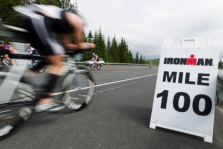 &lt;p&gt;SHAWN GUST/Press A cyclist zooms past a 100-mile marker Sunday during the bike portion of Ironman Coeur d'Alene.&lt;/p&gt;