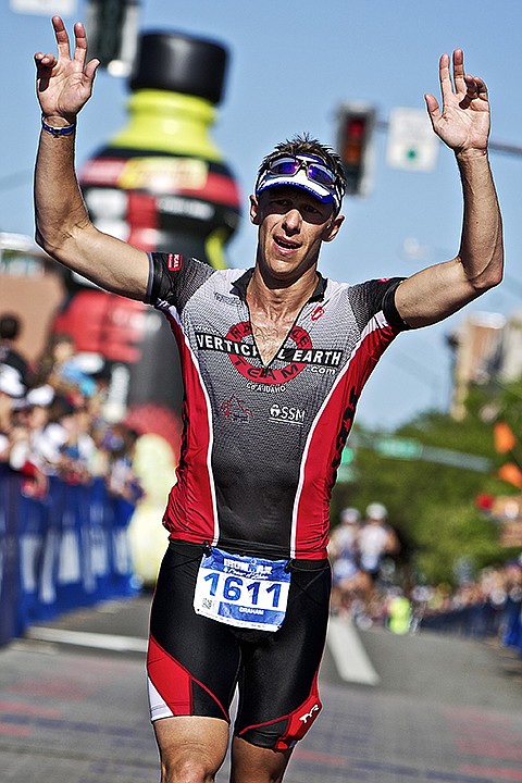 &lt;p&gt;JEROME A. POLLOS/Press Graham Christensen, from Coeur d'Alene, raises his arms as he crosses the finish line after completing the 140.6-mile Ironman Coeur d'Alene course with a time of 10:18:55.&lt;/p&gt;