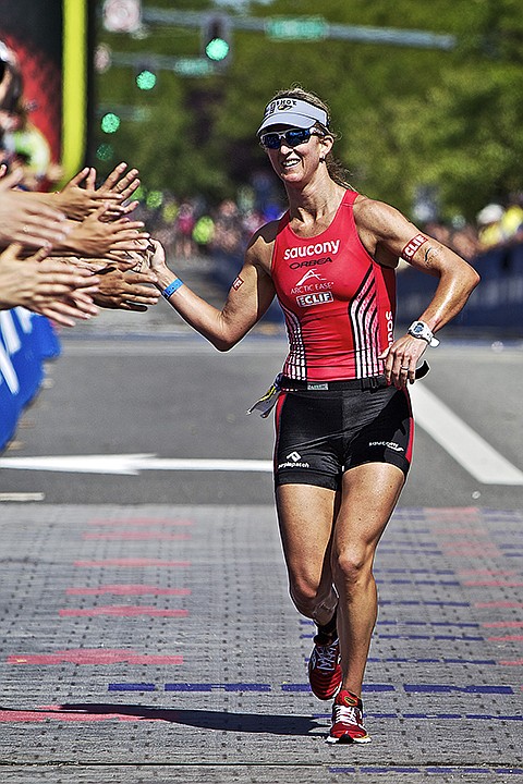 &lt;p&gt;JEROME A. POLLOS/Press Meredith Kessler, from San Francisco, celebrates with the Ironman Coeur d'Alene finish line spectators after completing the course in 9:21:44 to win the female division.&lt;/p&gt;