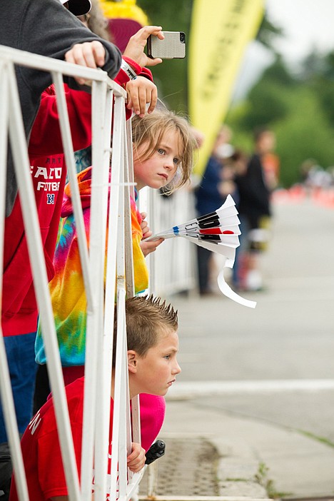 &lt;p&gt;Lauren, top, and Brayden, bottom, Bengston watch bicyclists from behind a barricade during the 2012 Ironman triathlon in Coeur d'Alene, Idaho Sunday.&lt;/p&gt;