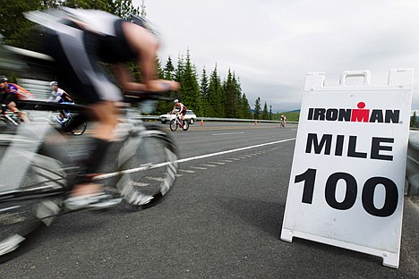 &lt;p&gt;A cyclist zooms past a 100-mile marker Sunday during the bike portion of Ironman Coeur d'Alene.&lt;/p&gt;