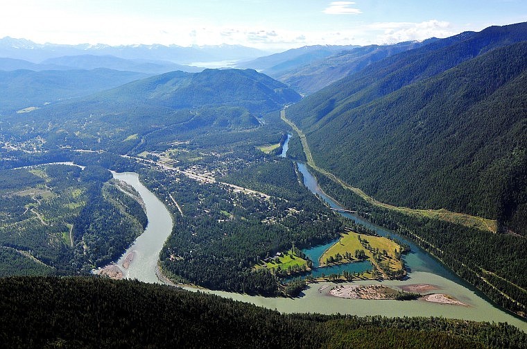 The main stem of the Flathead River, swollen and discolored by runoff and snow melt, connects with the South Fork of the Flathead near Hungry Horse. Hungry Horse Reservoir is in the distance.