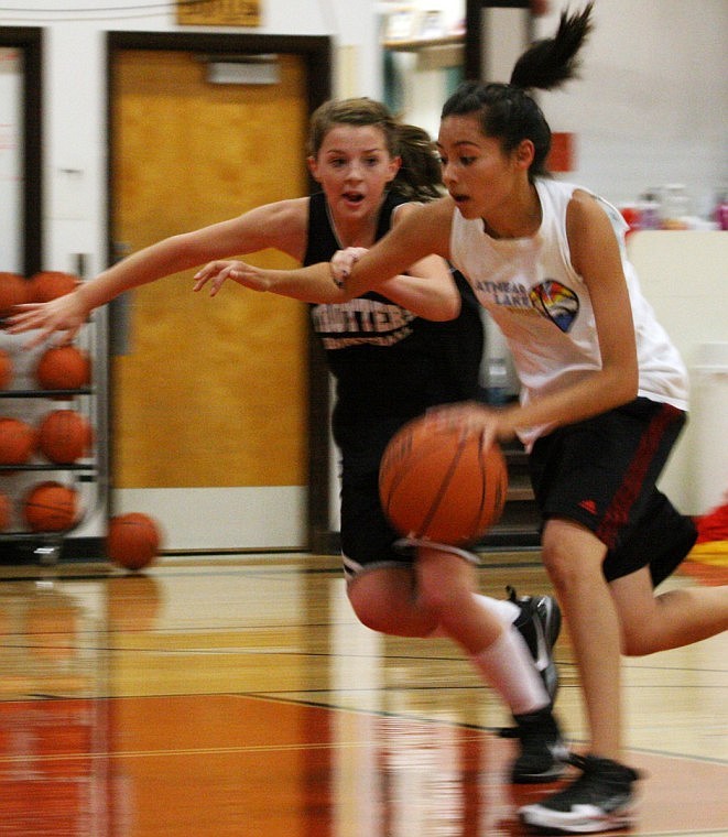 Diamond LaDeaux, right, drives the ball against Felicia Earhart, left, at the Trotter basketball camp.
