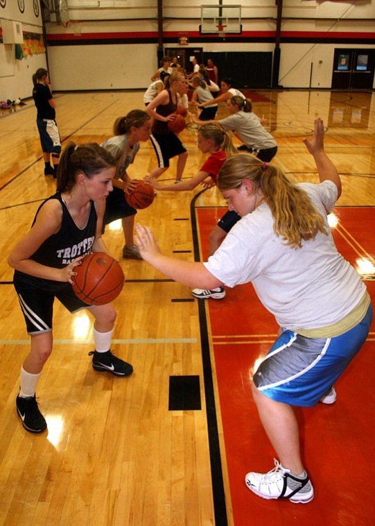 Tia Thompson, right, practices close out defense against Felicia Earhart at the Trotter basketball camp.