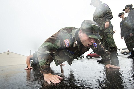 &lt;p&gt;Gage Wilson, a Coeur d'Alene US Airforce Auxiliary Civil Air Patrol cadet does pushups in a chain with other Air Patrol members while waiting in the rain for World War II aircrafts which were scheduled to arrive Tuesday afternoon. Clouds and rain prevented the planes from leaving Seattle on Monday and Tuesday.&lt;/p&gt;