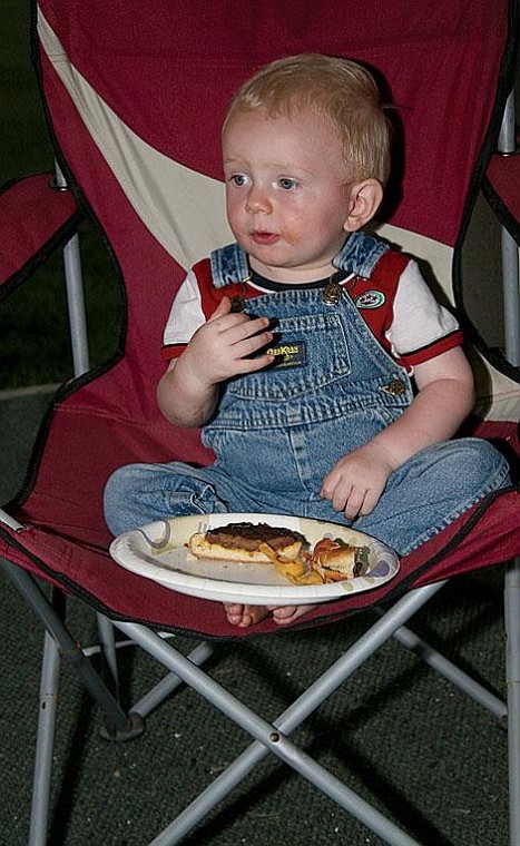 Photo by Nick Ianniello Jonah Lowry enjoys a hamburger at the St. Regis Campout Saturday night.