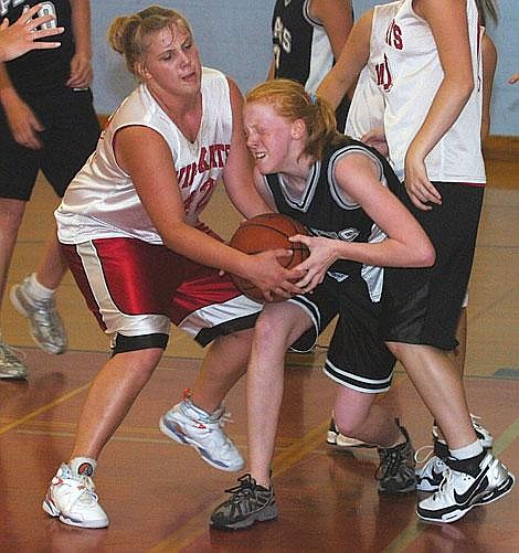 Photo by Trent Makela Trotter Laurel Danhof rips a rebound away from a Columbia Fallsdefender last Saturday in Ronan.