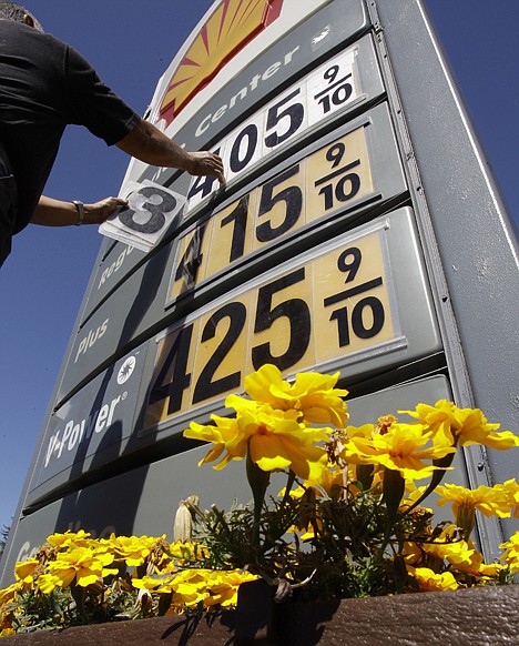 &lt;p&gt;Shell gas worker Toke Fusi lowers gas prices Tuesday at a Shell gas station in Menlo Park, Calif.&lt;/p&gt;