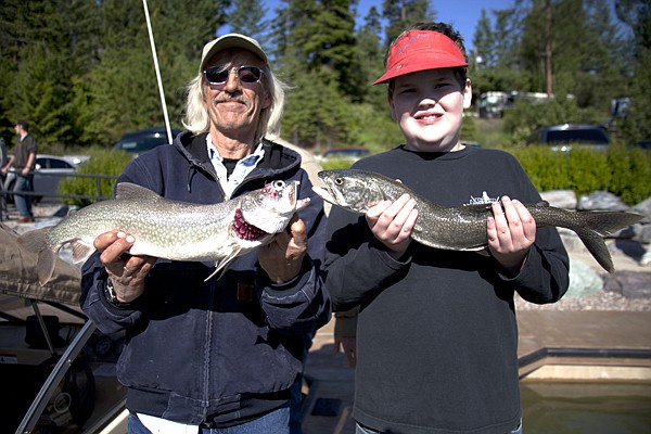 &lt;p&gt;Captain Tim Shattuck and 11-year-old Tristan Houk hold up lake trout they caught Thursday during the 19th Annual Fishing Without Barriers Day on Flathead Lake.&lt;/p&gt;