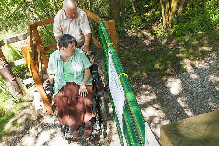 &lt;p&gt;Bob Lopp helps his wife Jane through the new wheelchair-accessible gate leading into the Owen Sowerwine Natural Area in Kalispell. Flathead Audubon unveiled the new accessible trail Friday afternoon. Friday, June 15, 2012 in Kalispell, Montana.&lt;/p&gt;