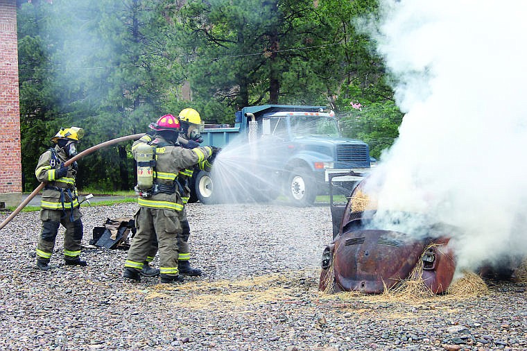 <p>Superior volunteer firefighters respond to a training call and practice techniques utilized to put out a car fire.</p>