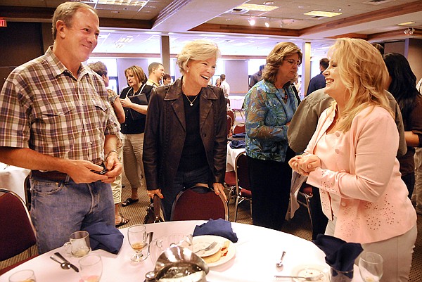 Mayor Tammi Fisher, right, speaks with Philip and Donna Harris after delivering the &quot;State of the City&quot; address on Wednesday at the Kalispell Chamber of Commerce June Luncheon.