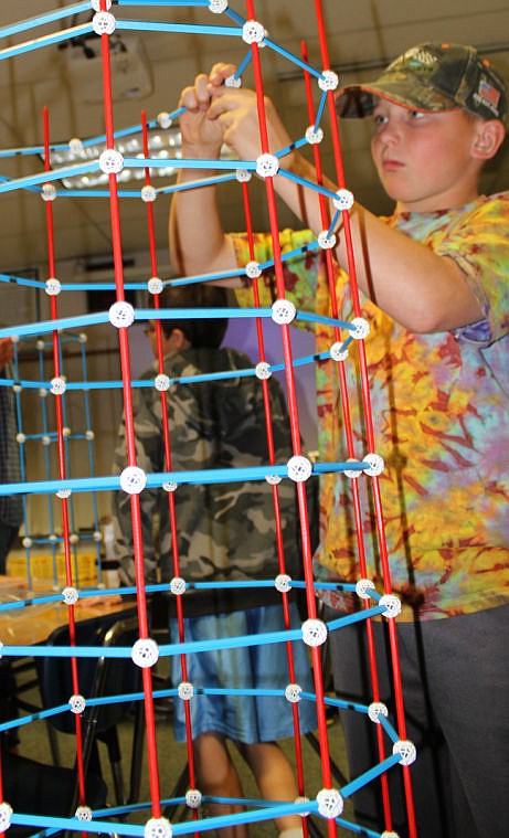 &lt;p&gt;Tristan Oberwegner, 11, whose mother is one of the camp teachers, builds his tower-prism.&lt;/p&gt;