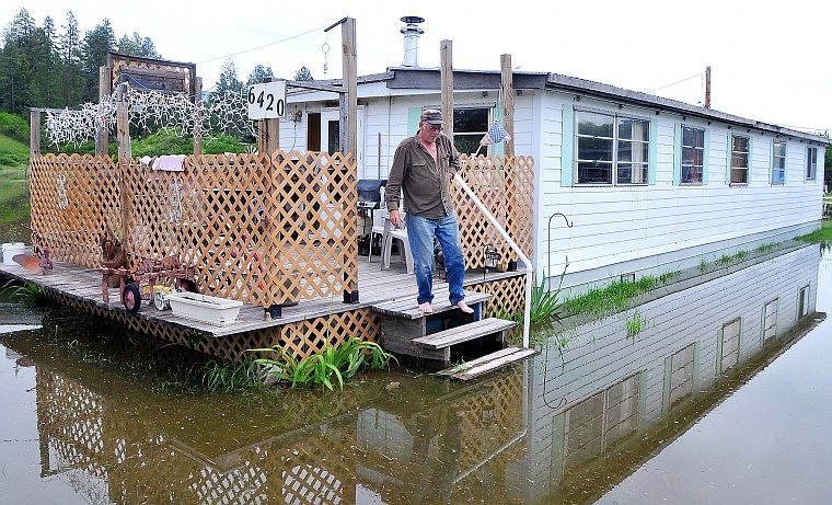 Jerry Stansberry watches his step off of his deck at his home near Trumbull Creek west of Columbia Falls on Wednesday afternoon. Water from the creek flooded Stansberry&#146;s property, but did not cause any damage to the interior of his home because it is raised 18 inches above the water.