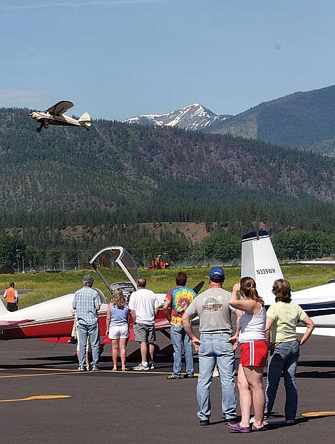 Photo by Aaric Bryan Spectators at the Fly-In Breakfast at the Plains Airport Saturday stop to watch one of the nearly 70 planes at the airport takeoff.