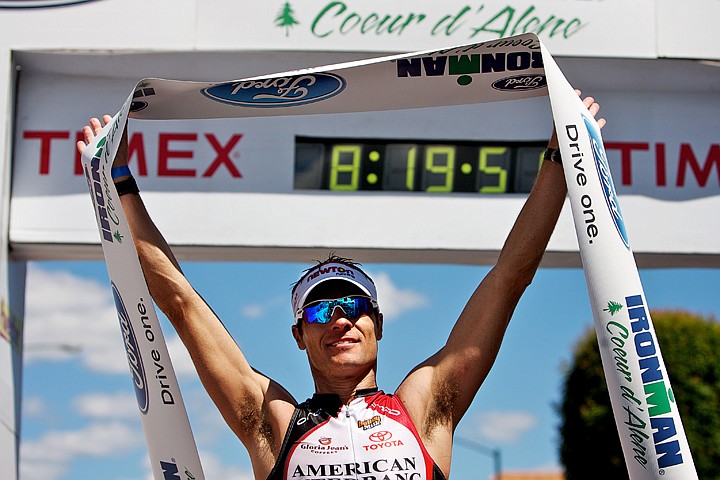 &lt;p&gt;JEROME A. POLLOS/Press Craig Alexander celebrates crossing the finish line of Ironman Coeur d'Alene in a record-setting time of 8:19:48 to win the event Sunday. Alexander's bicycle and marathon times established new course records.&lt;/p&gt;