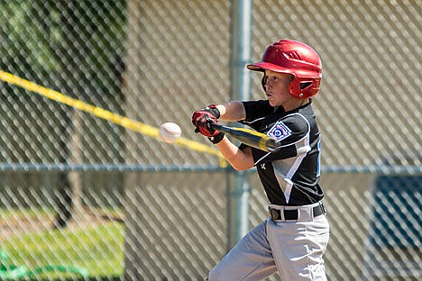 &lt;p&gt;Cameron Harris of the Coeur d'Alene Black makes contact with a ball during the second inning of an Idaho District 1 Little League age 9-10 game Friday afternoon at Canfield Middle School.&lt;/p&gt;