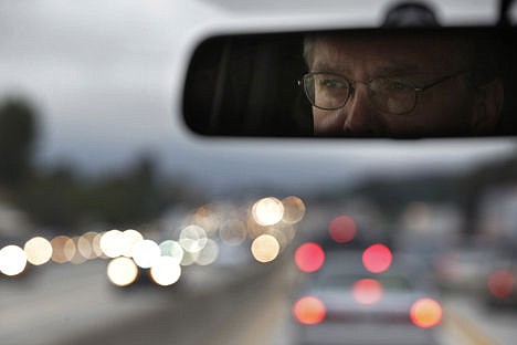 &lt;p&gt;UCLA employee and volunteer vanpool driver Fredrick Merrick, who commutes 80 miles each way from Moreno Valley, Calif., to the Westwood section of Los Angeles, is reflected in the rear view mirror as he drives a 12-passenger van through traffic on his way back home near Los Angeles on May 22.&#160;&lt;/p&gt;