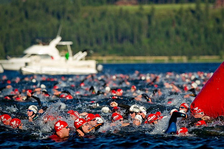 &lt;p&gt;JEROME A. POLLOS/Press Hundreds of triathletes converge at a turning point of the 2.4-mile swim during Sunday's Ford Coeur d'Alene Ironman.&lt;/p&gt;