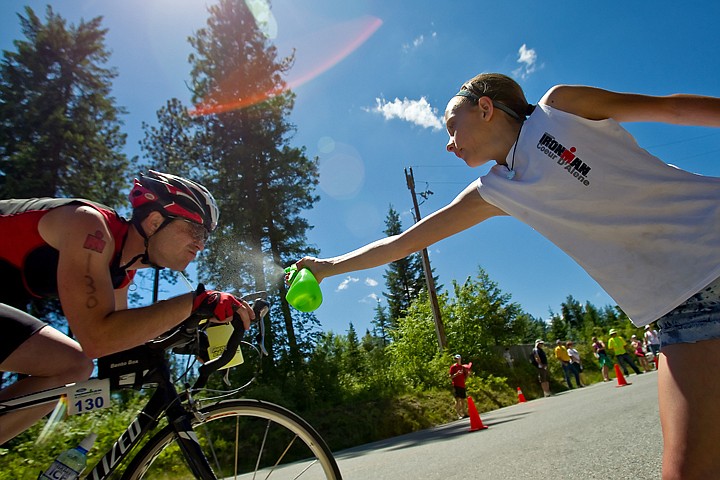 &lt;p&gt;JEROME A. POLLOS/Press Georgia Henkle, 10, spritzes Cameron Hjeltness, from Post Falls, with a water as he pedals along Dodd Road.&lt;/p&gt;