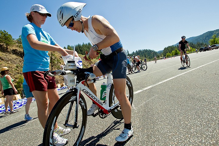 &lt;p&gt;JEROME A. POLLOS/Press Kelly Lynch helps Thomas Wood, from Pacific Palasades, Calif., retrieve snacks and beverages from his supply bag at an aide station at Higgens Point along the 112-mile bicycle route.&lt;/p&gt;