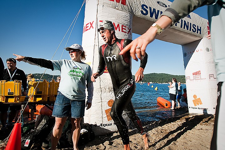 &lt;p&gt;BEN BREWER/Press Professional Ironman competitor John Flanagan turns out of the water and gets guided to the first transition zone by volunteer workers.&lt;/p&gt;