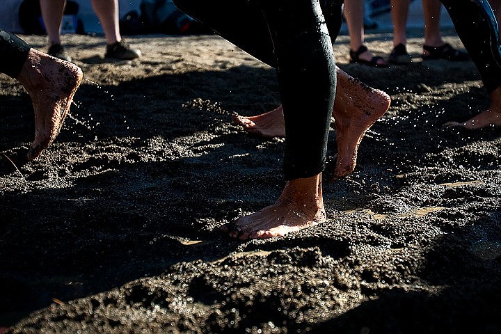 &lt;p&gt;BEN BREWER/Press Feet thundered around the first turnaround halfway through the swim portion of Sunday's Ironman competition in Coeur d'Alene as sand quickly turned to soggy mud along the shore.&lt;/p&gt;
