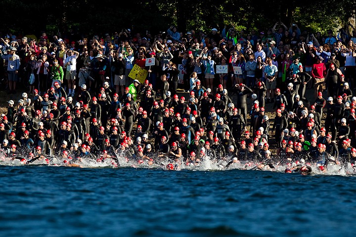 &lt;p&gt;JEROME A. POLLOS/Press A mass of Ford Coeur d'Alene Ironman participants race down the City Beach and into the water after the starting cannon was shot Sunday.&lt;/p&gt;