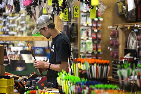 &lt;p&gt;Scott Siebert marks prices on arrows at the archery counter at the new location of Black Sheep Sporting Goods on Government Way in Coeur d'Alene.&lt;/p&gt;