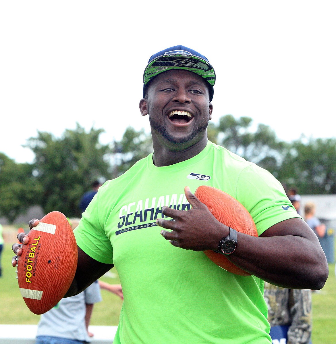 Seattle Seahawks rookie offensive lineman Rees Odhiambo throws passes to North Elementary School students