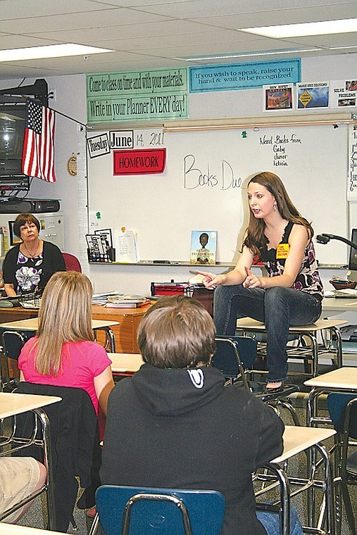 Analiesse Isherwood talks to an eighth grade social studies
class, who helped raise approximately $1,000 for Haitian students,
at Chief Moses Middle School Tuesday.
