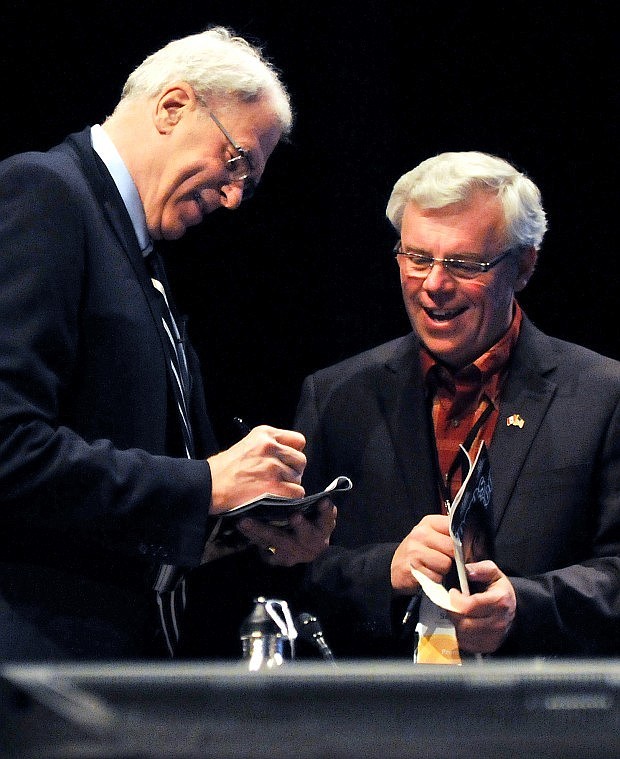 Jackson gives Manitoba Premier Greg Selinger an autograph before the start of the meeting.