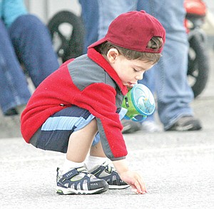 &lt;p&gt;Armed with a &quot;sippy&quot; cup, two-year-old Nik Arunachalan gathers candy during the Logger Days Parade.&lt;/p&gt;