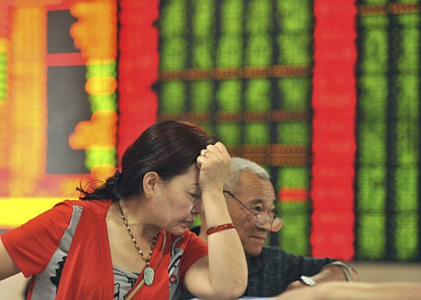 &lt;p&gt;Investors react as they check stock prices in a brokerage house in Fuyang in central China's Anhui province Friday.&#160;&lt;/p&gt;