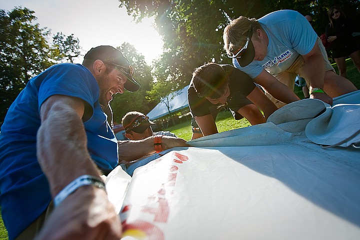 &lt;p&gt;BEN BREWER/Press Mac Brown, left, with WTC Ironman, gives a firm pull to dismantle the tarp of the Newton Running shoe company tent in City Park Saturday evening in preparation for Sunday's Ford Ironman competition.&lt;/p&gt;