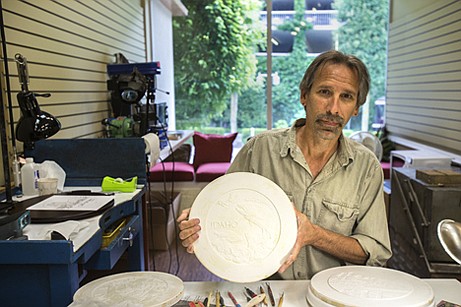 &lt;p&gt;Randy Kramer holds up a completed plaster cast with &quot;Idaho&quot; and a jumping trout on it. Casts like this one are the templates Kramer uses to create silver medallions at his new store Gem State Mint.&lt;/p&gt;