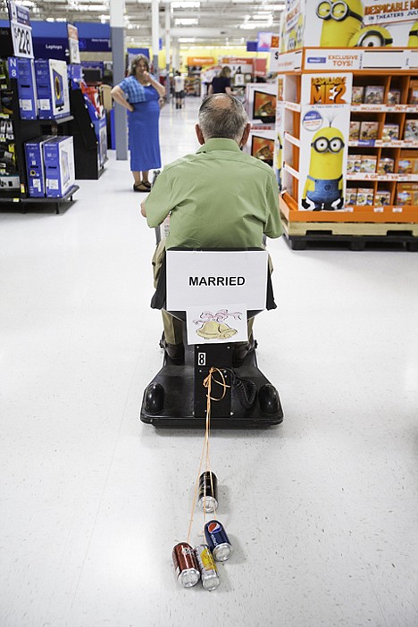 &lt;p&gt;Donald Evans rides a store scooter adorned with tin cans through the aisles of Walmart.&lt;/p&gt;