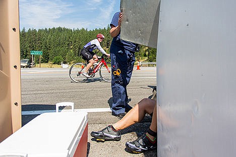 &lt;p&gt;A fellow competitor looks on as Scott Volon lays on the ground while receiving medical attention during the bike portion of the Coeur d'Alene Ironman on Sunday. Volon did not finish the race.&lt;/p&gt;