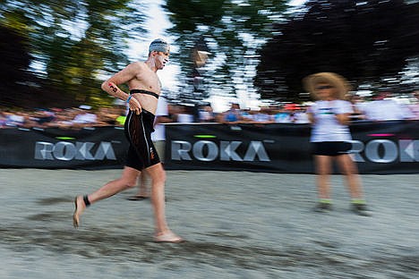 &lt;p&gt;After exiting the water, professional triathlete Doug Maclean, of Ithaca, NY, races across the beach on his way to the bike transition area.&lt;/p&gt;