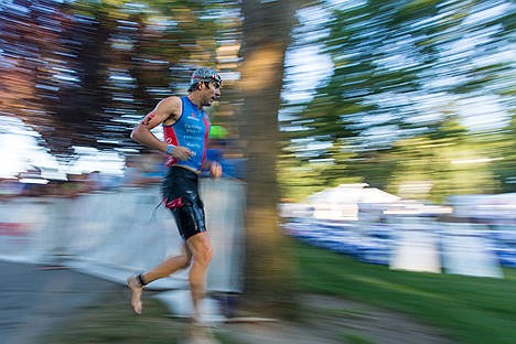 &lt;p&gt;Trevor Delsaut runs to the transition area after completing the swimming portion of the Coeur d'Alene Ironman. Delsaut finished the race in 8:47:49 on Sunday.&lt;/p&gt;