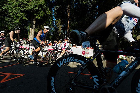 &lt;p&gt;Age group competitors mount their bikes after moving through the transition from the swim.&lt;/p&gt;