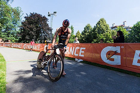 &lt;p&gt;In the lead, Andy Potts dismounts his bike before making the transition to the run. Potts won the event with an overall time of 8:20:35.&lt;/p&gt;