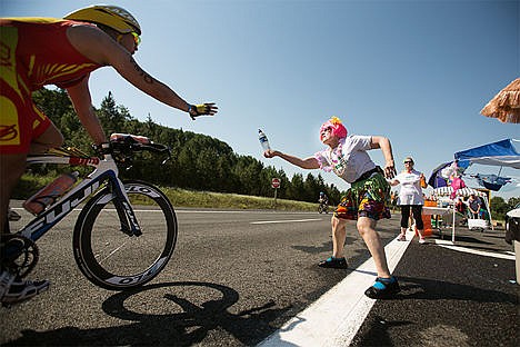 &lt;p&gt;Fran Snavely of Hayden assists Ironman participant Robert Smith of Valdez Alaska with some water on Highway 95 during the race Sunday.&lt;/p&gt;