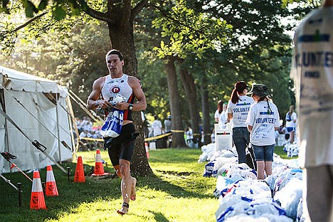 &lt;p&gt;Michael Starkey, apart of the men&#146;s professional division, runs from the water to the transition station to go onward to the bike portion of the race starting from Coeur d&#146;Alene City Park.&lt;/p&gt;