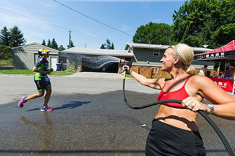 &lt;p&gt;With temperatures in the triple digits, Stephanie Lahr sprays water onto passing triathletes during the run portion of Ironman.&lt;/p&gt;